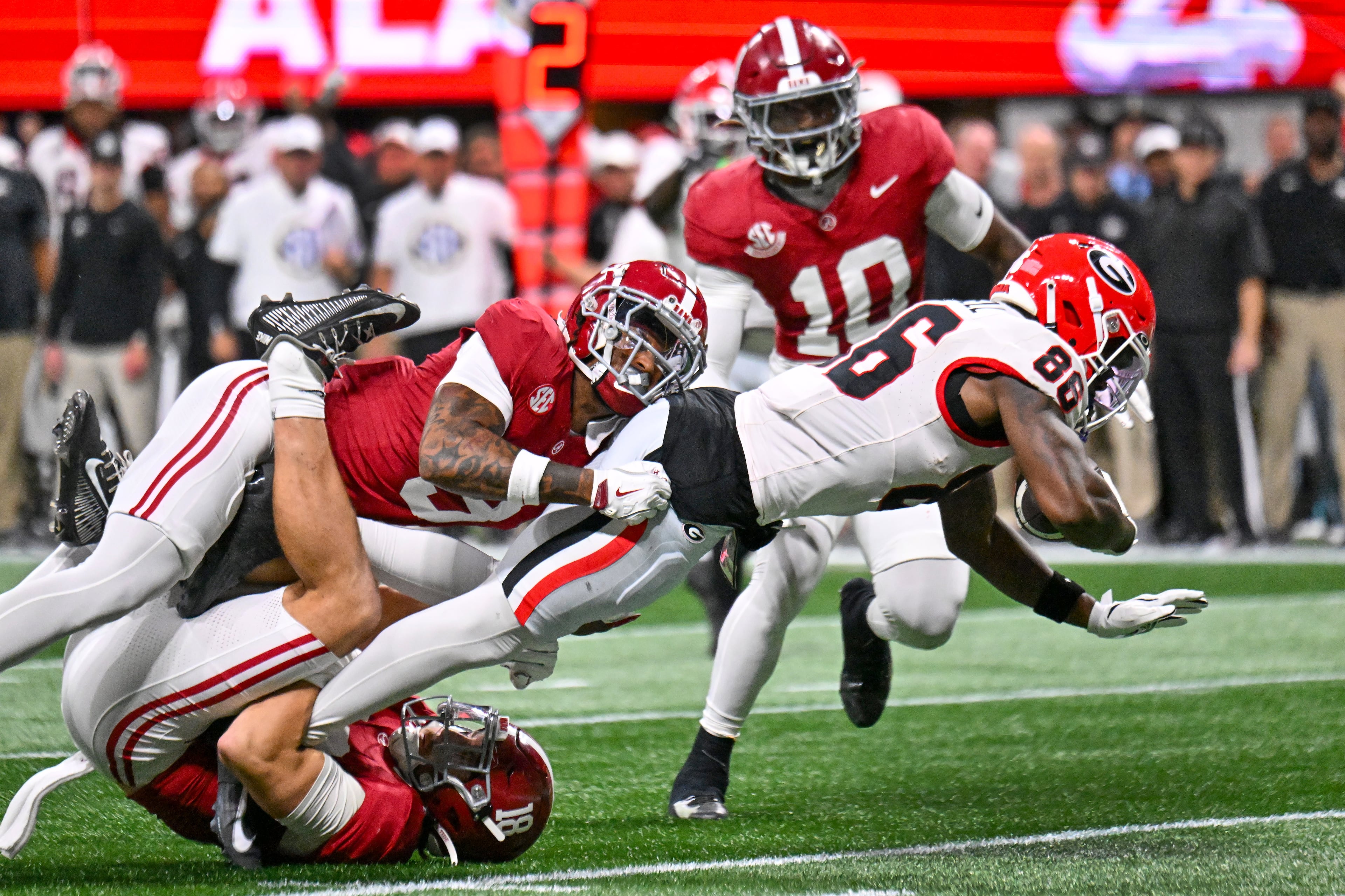 Georgia defensive back Daylen Everette (6)) celebrates with Kj Bolden (4) after intercepting a pass from Alabama quarterback Ty Simpson during the first half of the SEC Championship game at Mercedes-Benz Stadium, Saturday, Dec. 6, 2025, in Atlanta. (Hyosub Shin / AJC)