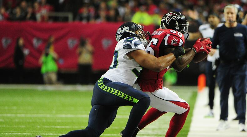 ATLANTA, GA - JANUARY 14: Tevin Coleman #26 of the Atlanta Falcons is forced out of bounds by J.D. McKissic #30 of the Seattle Seahawks at the Georgia Dome on January 14, 2017 in Atlanta, Georgia. (Photo by Scott Cunningham/Getty Images)