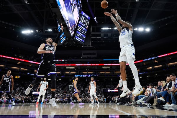 Dallas Mavericks forward P.J. Washington (25) shoots a 3-point basket over Sacramento Kings guard Zach LaVine (8) during the first half of an NBA play-in tournament basketball game Wednesday, April 16, 2025, in Sacramento, Calif. (AP Photo/Godofredo A. Vásquez)