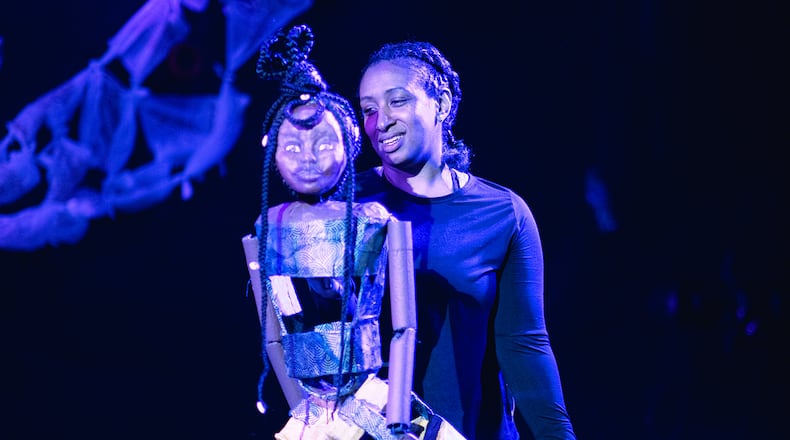 Actress Kahalilah Smith manipulates the human puppet in a production of "Human," continuing through Jan. 28 at the Center for Puppetry Arts.