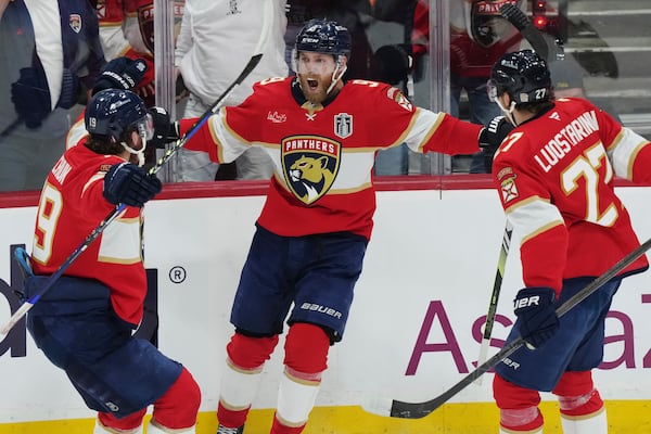 Florida Panthers' Sam Bennett (9) celebrates his goal against the Edmonton Oilers with Matthew Tkachuk (19) and Eetu Luostarinen (27) during the second period in Game 3 of the NHL hockey Stanley Cup finals in Sunrise, Fla., Monday, June 9, 2025. (Nathan Denette/The Canadian Press via AP)
