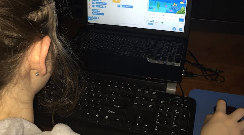 Catey Iacono, a student enrolled in the 8-week basic Scratch workshop hosted by the Forsyth County Public Library is shown editing her Dodging the Shark game she had for homework. The fish has to dodge the shark to get over to the sea anemone.