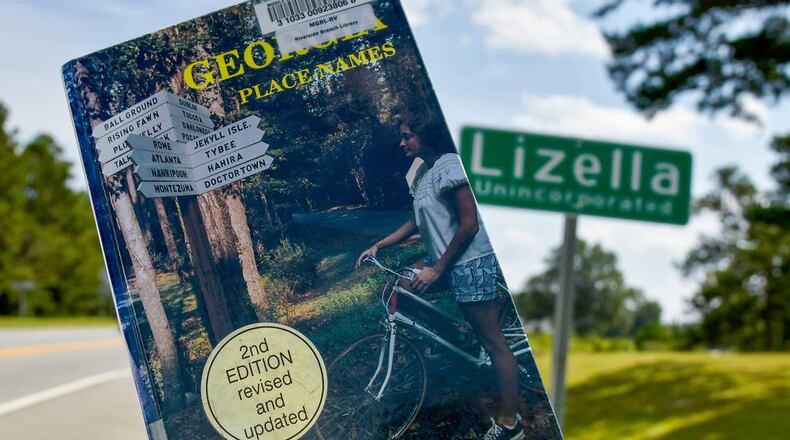 A copy of Kenneth Krakow’s “Georgia Place-Names” displayed for this photograph by the sign at the Lizella town limits. According to the book, Lizella, in western Bibb County, was named by an early postmaster, James A. Eubanks, for his two daughters, Lizzy and Ella. (Photo Courtesy of Jason Vorhees/The Telegraph)