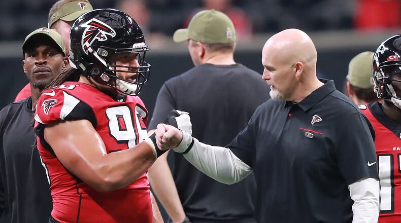Falcons head coach gives defensive tackle Tyeler Davison a fist bump before facing the Buccaneers Sunday, Nov. 24, 2019, at Mercedes-Benz Stadium in Atlanta.