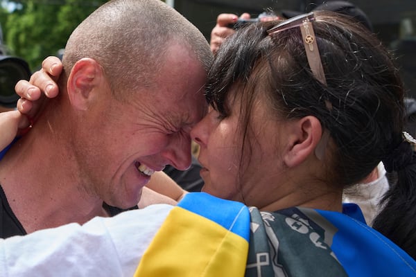 A Ukrainian serviceman Vitaly, hugs his wife Olena, after returning from captivity during a POWs exchange between Russia and Ukraine, in Chernyhiv region, Ukraine, Sunday, May 25, 2025. (AP Photo/Efrem Lukatsky)