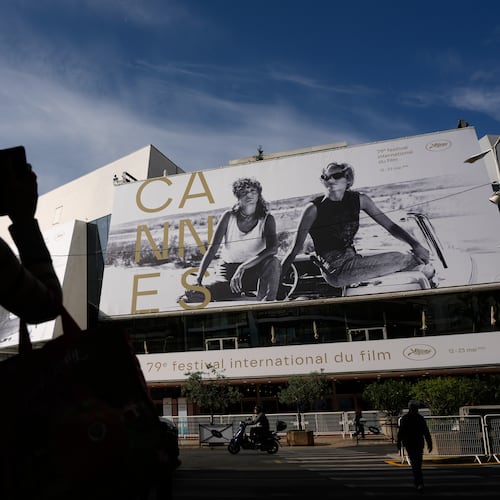 A person takes a photo outside the Palais des Festivals during preparations for the 79th international film festival, Cannes, southern France, Monday, May 11, 2026. (AP Photo/John Locher)