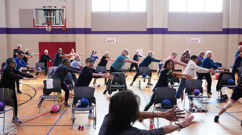 Instructor Bengie Santos, 72, at front, leads an exercise class for older adults at the Dale Turner Family YMCA, April 30, 2026, in Shoreline, Wash. (AP Photo/Lindsey Wasson)