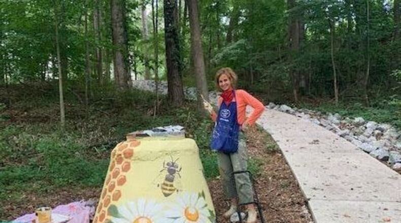 Dr. Angelika Domschke is using her painting talents to make otherwise unsightly manholes more enjoyable along the Hunter-Walker Trail in Norcross.