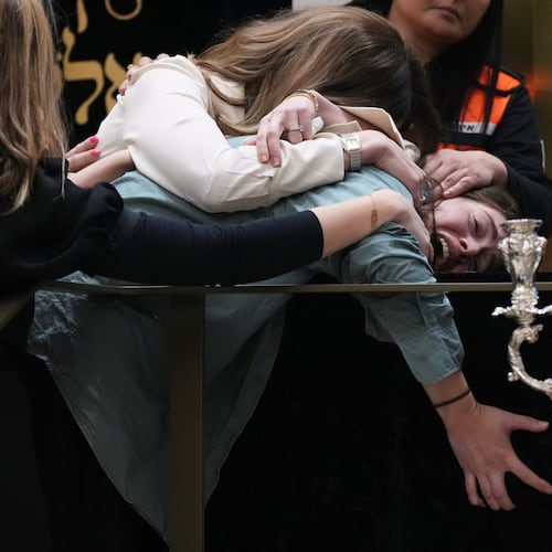 Family react at the coffin of Rabbi Eli Schlanger, a victim in the Bondi Beach mass shooting, during his funeral at a synagogue in Bondi on Wednesday, Dec. 17, 2025, in Sydney, Australia. (AP Photo/Mark Baker, Pool)