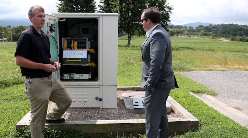 Daniel Frizzell, the director of engineering at Blue Ridge Mountain EMC, left, explains the way in which Blue Ridge Mountain EMC provides internet services to rural areas with Jeremy Nelms, manager of Blue Ridge Mountain EMC, listening. Jenna Eason / Jenna.Eason@coxinc.com