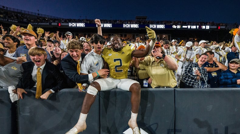 Georgia Tech linebacker Ayinde Eley celebrates with students after the Yellow Jackets' 23-20 overtime win over Duke Oct. 8, 2022 at Bobby Dodd Stadium. (Danny Karnik/Georgia Tech Athletics)