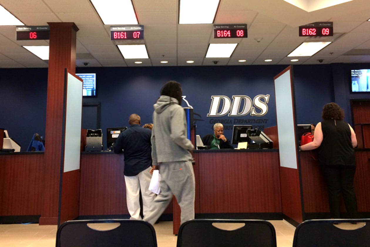 Georgia automatically registers eligible voters at driver's license offices unless they click a button to opt out. State lawmakers are considering whether to keep or eliminate the program. (File/AJC)