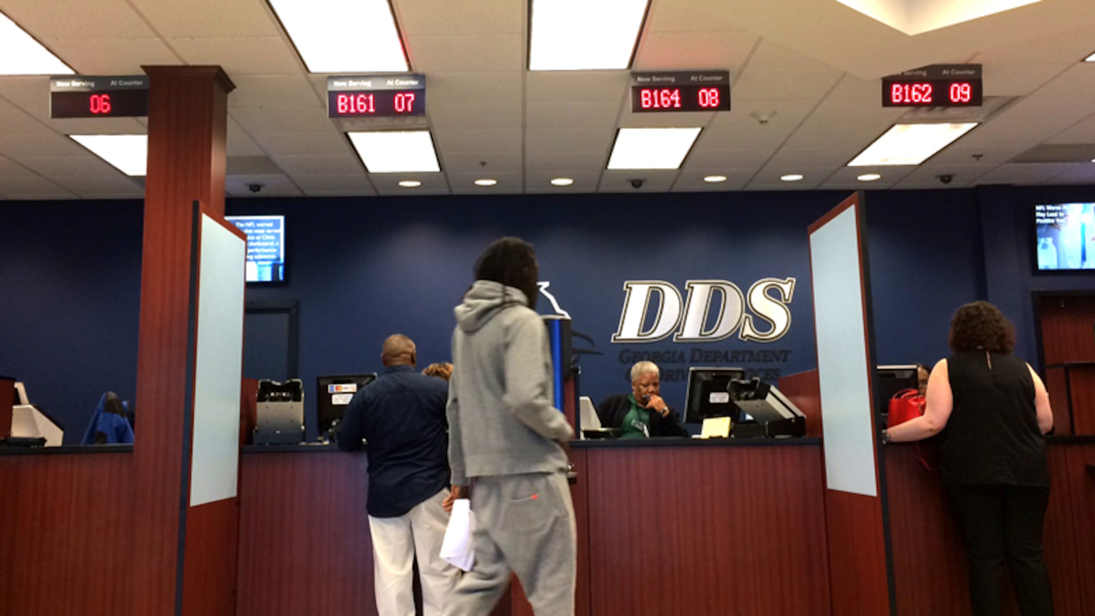 Georgia automatically registers eligible voters at driver's license offices unless they click a button to opt out. State lawmakers are considering whether to keep or eliminate the program. (File/AJC)