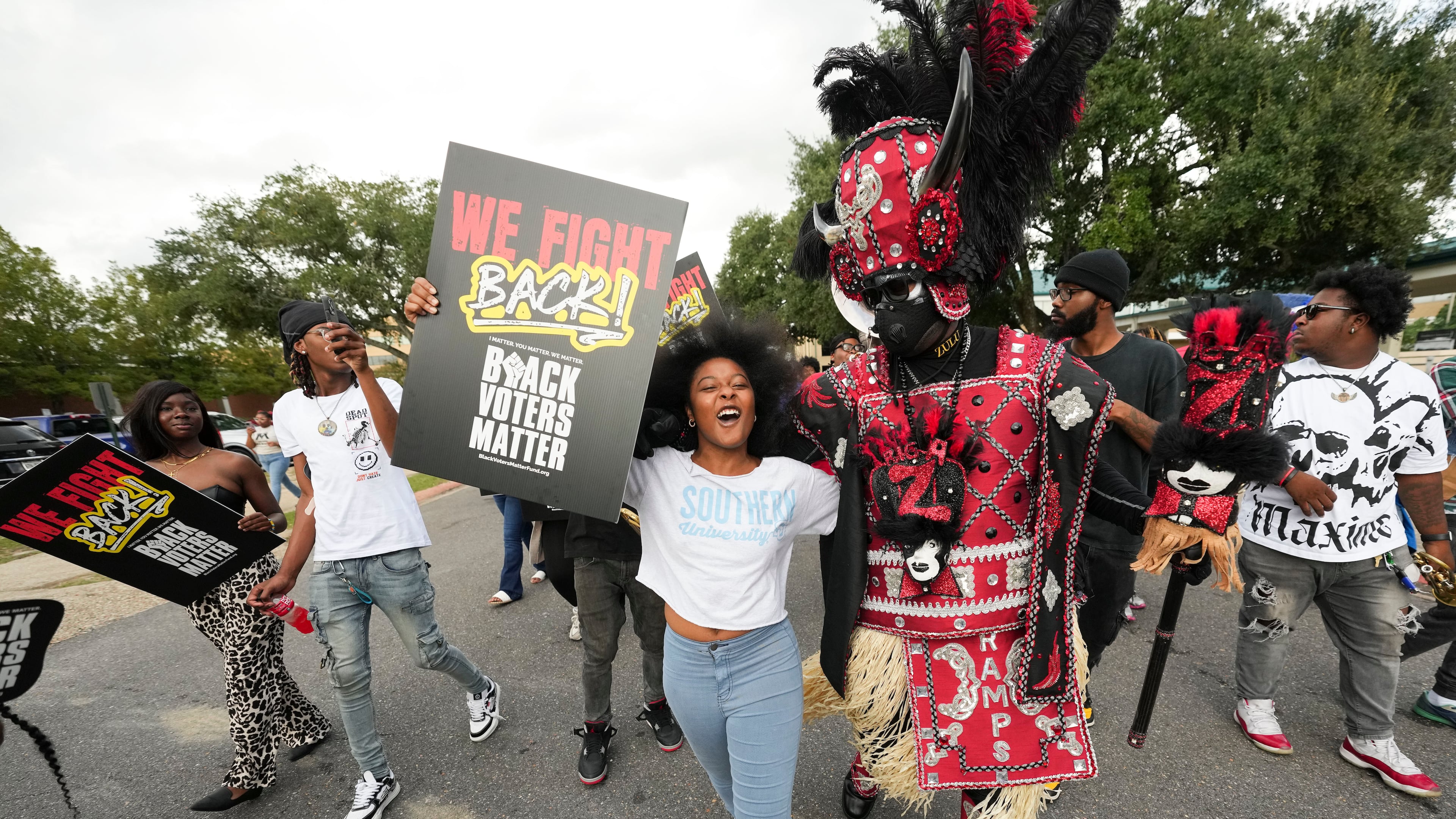 FILE - Students and a member of the Zulu Tramps march to a campus polling place on Election Day at Southern University in Baton Rouge, La., Nov. 5, 2024. (AP Photo/Gerald Herbert, File)