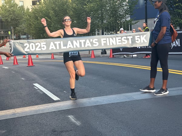 A runner approaches the finish line of the Atlanta's Finest 5K race on Saturday, Aug. 16, 2025. For some, the race was less about breaking personal records and more about supporting the race’s cause. (Caleb Groves/AJC)