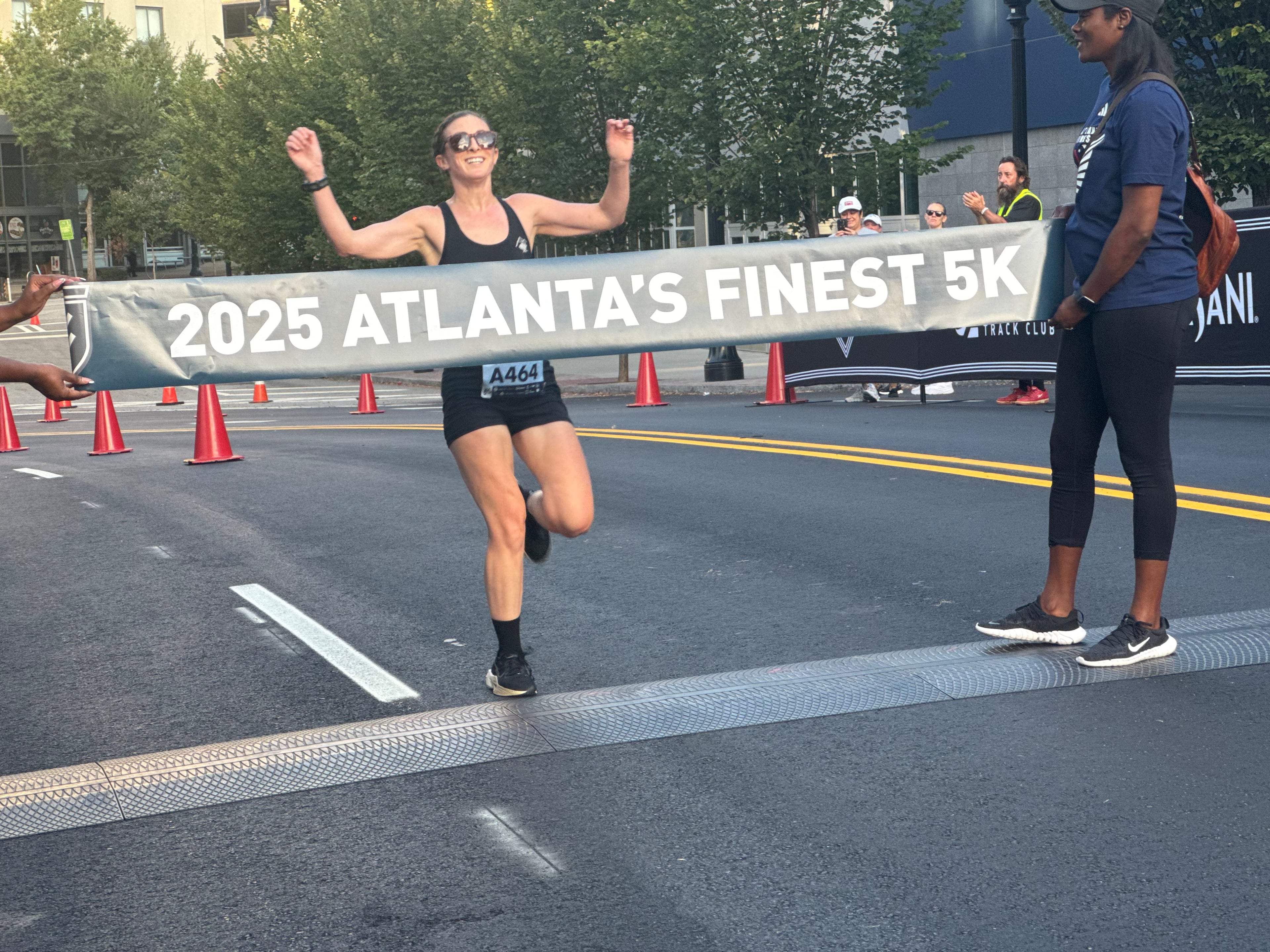 A runner approaches the finish line of the Atlanta's Finest 5K race on Saturday, Aug. 16, 2025. For some, the race was less about breaking personal records and more about supporting the race’s cause. (Caleb Groves/AJC)