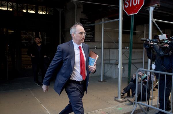 
                        Chris Conroy, a prosecutor with the Manhattan district attorney's office, walks between Manhattan Criminal Court buildings in Manhattan, March 30, 2023. A Manhattan grand jury voted to indict Donald J. Trump on Thursday for his role in paying hush money to a porn star, according to four people with knowledge of the matter. (Anna Watts/The New York Times)
                      