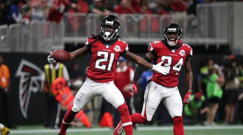 Atlanta Falcons cornerback Desmond Trufant (21) celebrates his interception with cornerback Brian Poole (34) in the second quarter of their game against the Green Bay Packers at Mercedes-Benz Stadium.