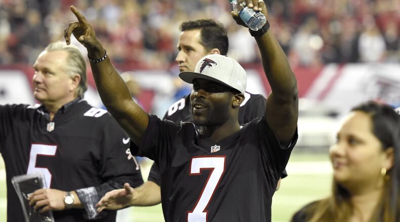 Former Falcons quarterback Michael Vick (7) greets fans at the Georgia Dome during a game against the Saints in Atlanta, Georgia, on Sunday, Jan. 1, 2017. (David Barnes/david.barnes@ajc.com)