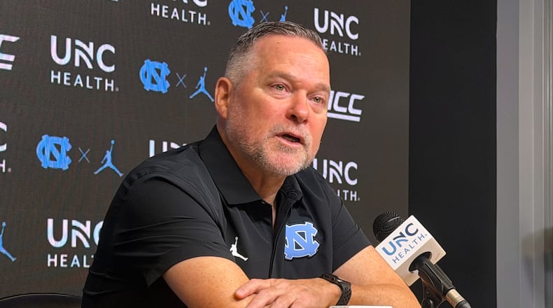 In this photo taken with a smartphone, North Carolina men's basketball head coach Michael Malone speaks during a news conference Thursday, Sept. 3, 2026, in Chapel Hill, N.C. (AP Photo/Aaron Beard)