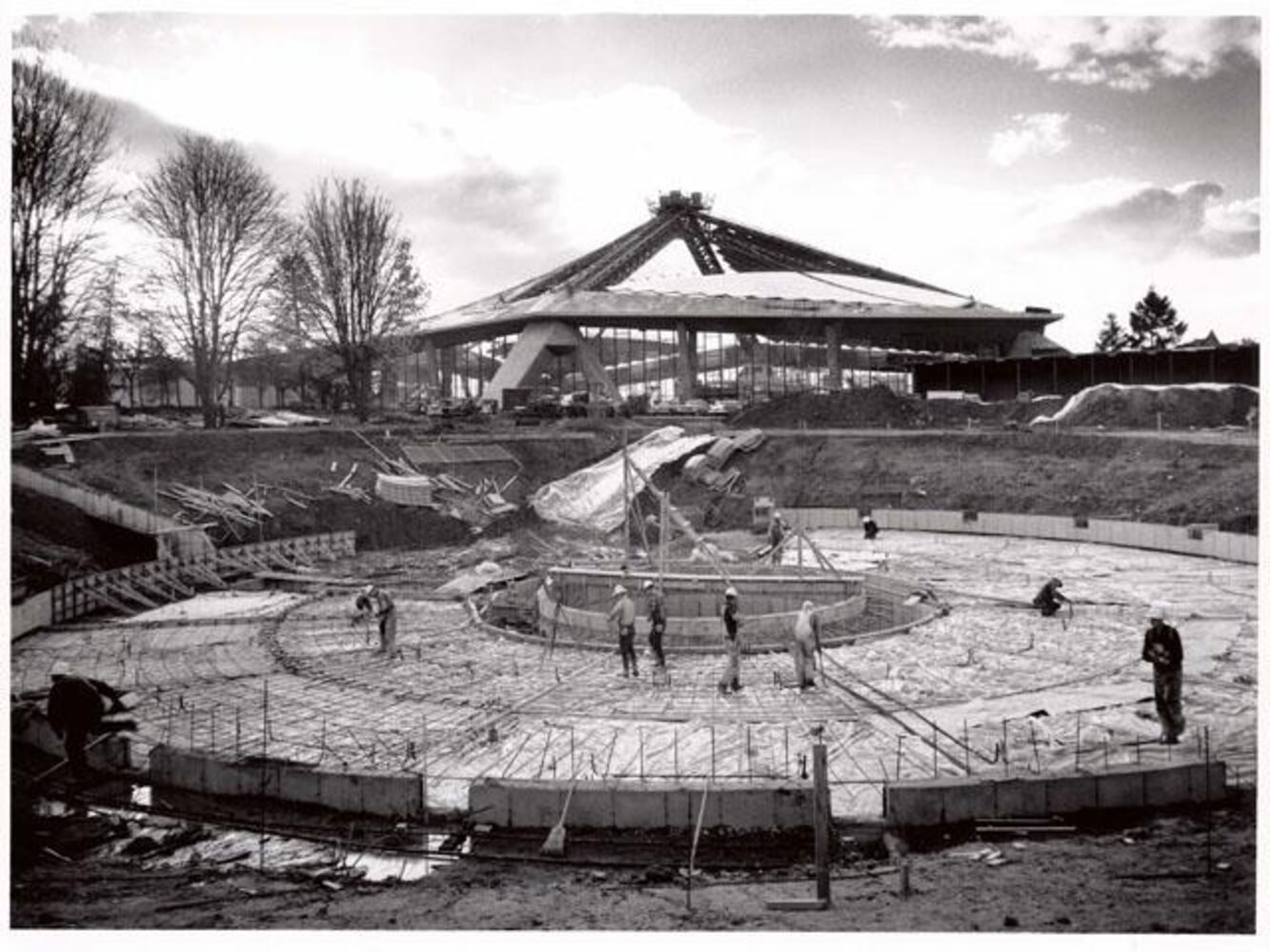 Workers prepare rebar and concrete for the International Fountain base.