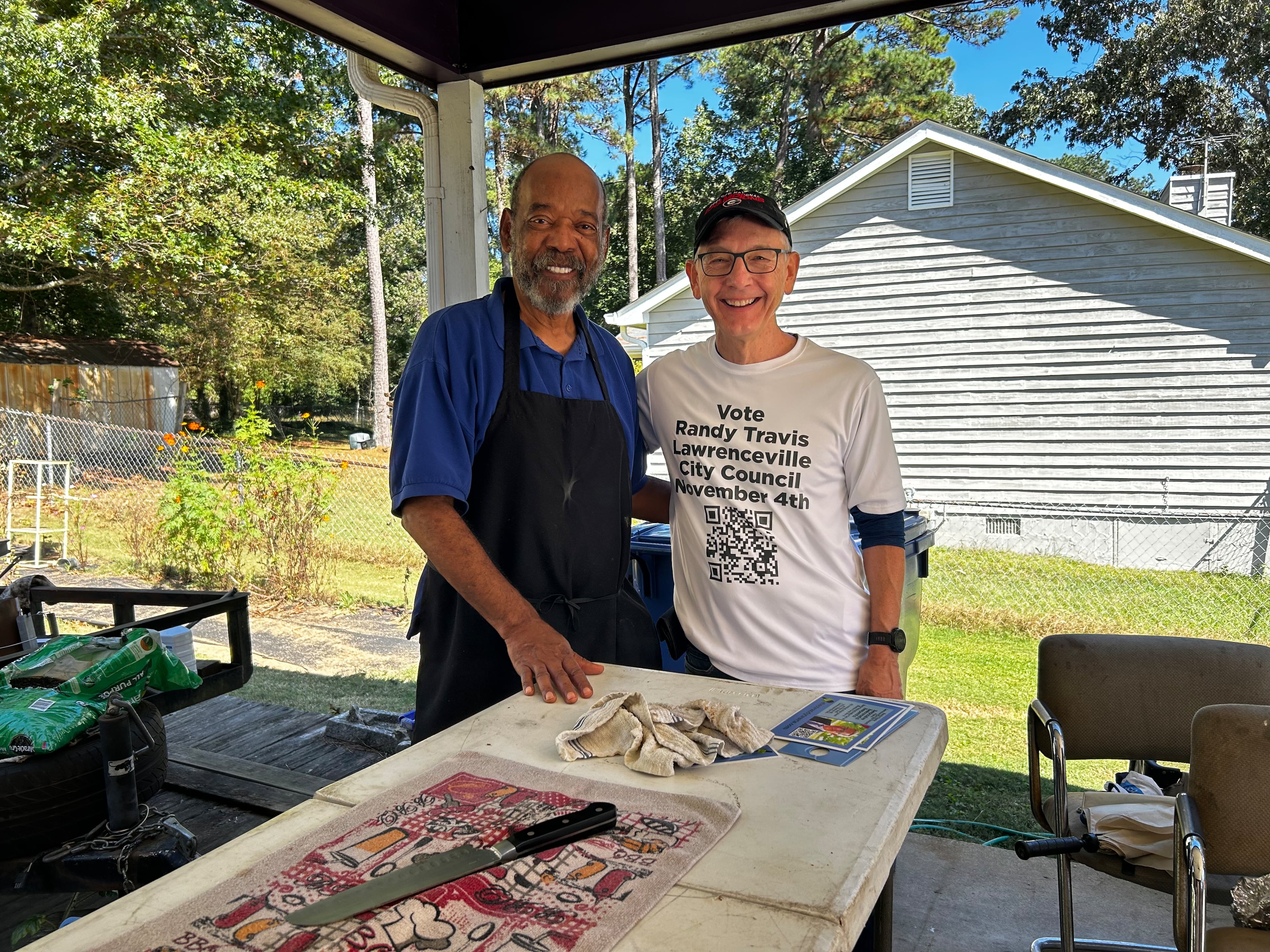 Randy Travis meets Lawrenceville constituent and pastor John Dennis while visiting homes campaigning in 2025 for Lawrenceville city council. (Contributed)