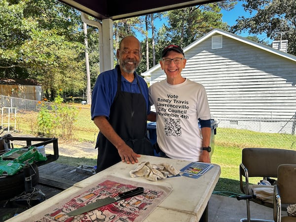 Randy Travis meets Lawrenceville constituent and pastor John Dennis while visiting homes campaigning in 2025 for Lawrenceville city council. (Contributed)