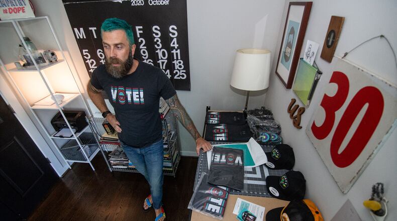 Buzz Busbee, owner of the T-shirt and clothing design brand AbetterBuzz, works in his home office in Atlanta on Oct. 3, 2020. STEVE SCHAEFER / SPECIAL TO THE AJC
