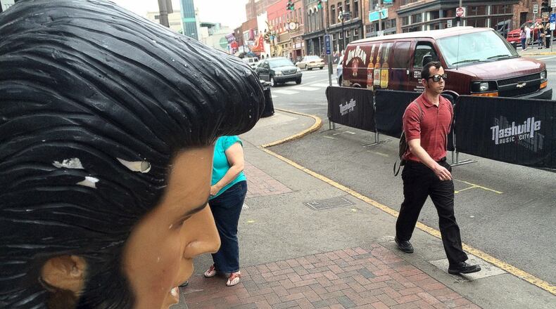 A Fiberglas Elvis is caught in permanent "uh-huh-huh" in downtown Nashville, where the governor recently vetoed a bill making the Bible the state book of Tennessee. Other lawmakers across the country are dealing with bills with religious subtexts. MARK DAVIS/MRDAVIS@AJC.COM