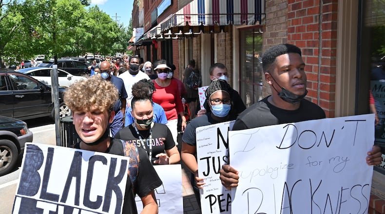 John Kirbymurdoch. left, and Alex Williams, both 16 and students at Morgan County High School, lead a peaceful, youth-led march in downtown Madison in June. (Hyosub Shin / Hyosub.Shin@ajc.com)