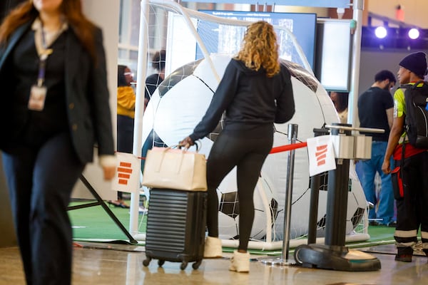 A traveler looks at the "From Gates to Goals" exhibit celebrating the upcoming FIFA World Cup at Hartsfield-Jackson Atlanta International Airport's international terminal in Atlanta on May 27, 2026. (Arvin Temkar/AJC)
