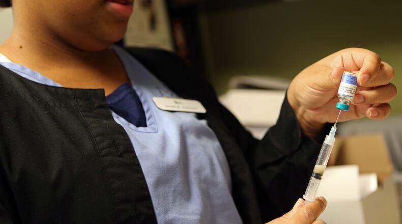 Brianna Gilyard, lead medical assistant at Intown Pediatrics & Adolescent Medicine, prepares a measles, mumps and rubella vaccine.