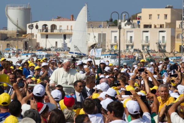 FILE - Pope Francis waves to faithful as he is driven through the crowd during his visit to the island of Lampedusa, southern Italy, Monday July 8, 2013. (AP Photo/Alessandra Tarantino, file)