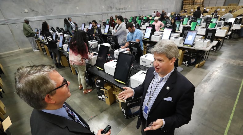 AJC politics reporter Mark Niesse (left) interviews Gabriel Sterling, implementation manager for Georgia’s new voting system with the Georgia Secretary of State’s office. (Curtis Compton / ccompton@ajc.com)