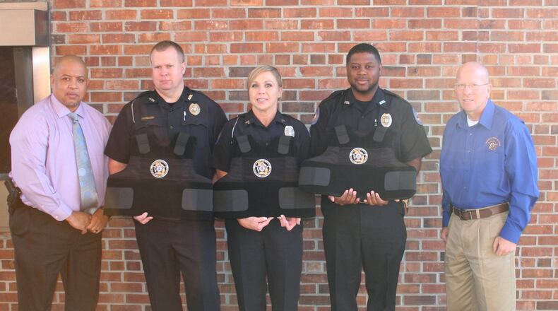 Representatives of the Georgia Fraternal Order of Police present three ballistic vests to the Ashburn Police Department. Telemarketers who raise money for the order tell potential donors that money is needed for vests, to help families of injured officers and to pay operating expenses. But most donations go to the commercial fundraisers.