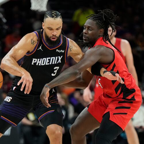 Portland Trail Blazers guard Jrue Holiday (5) tips the ball away from Phoenix Suns forward Dillon Brooks (3) during the first half of an NBA play-in tournament basketball game, Tuesday, April 14, 2026, in Phoenix. (AP Photo/Ross D. Franklin)