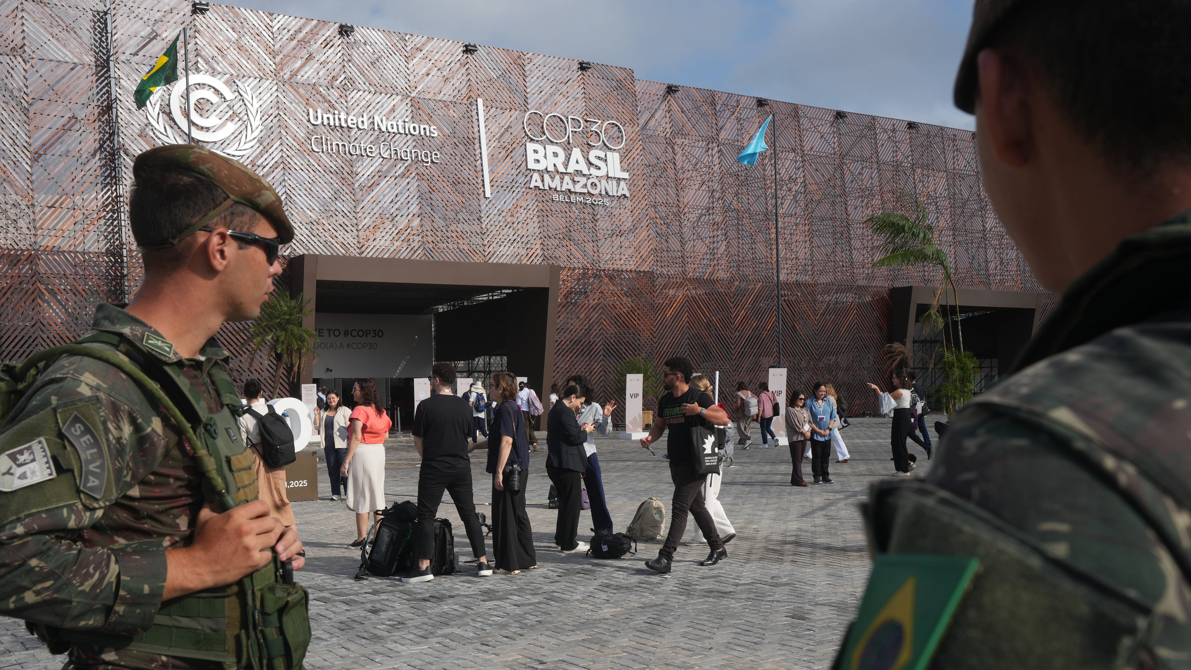 Security personnel monitor as attendees arrive to the COP30 U.N. Climate Summit, Tuesday, Nov. 18, 2025, in Belem, Brazil. (AP Photo/Andre Penner)