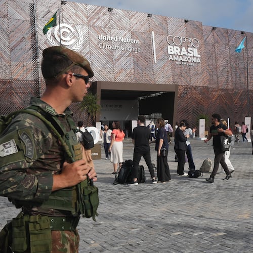 Security personnel monitor as attendees arrive to the COP30 U.N. Climate Summit, Tuesday, Nov. 18, 2025, in Belem, Brazil. (AP Photo/Andre Penner)