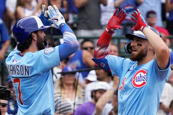 Chicago Cubs' Michael Busch, right, is greeted by Dansby Swanson (7) after hitting a two-run home run against the St. Louis Cardinals during the third inning of a baseball game Friday, July 4, 2025, in Chicago. (AP Photo/David Banks)