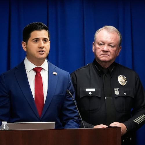 Acting U.S. Attorney Bill Essayli, left, speaks next to Los Angeles Police Chief Jim McDonnell during a news conference announcing an arrest made in the Palisades Fire, Wednesday, Oct. 8, 2025, in Los Angeles. (AP Photo/Damian Dovarganes)