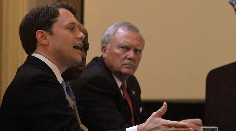 Gov. Nathan Deal and Democratic state Sen. Jason Carter meet at an education forum hosted by the Professional Association of Georgia Educators in Atlanta on Monday. Kent D. Johnson, kdjohnson@ajc.com