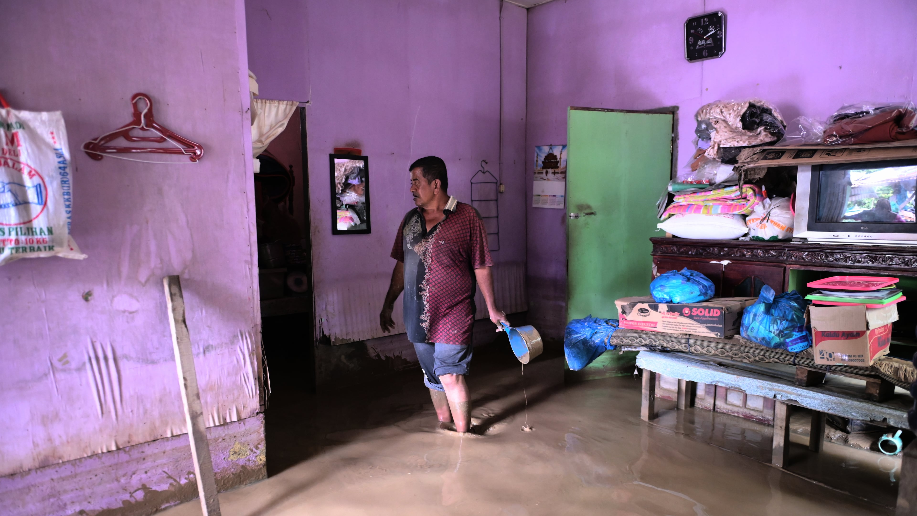 A man stands inside his flooded home in Pidie Jaya, Aceh province, Indonesia, Wednesday, Dec. 3, 2025. (AP Photo/Reza Saifullah)