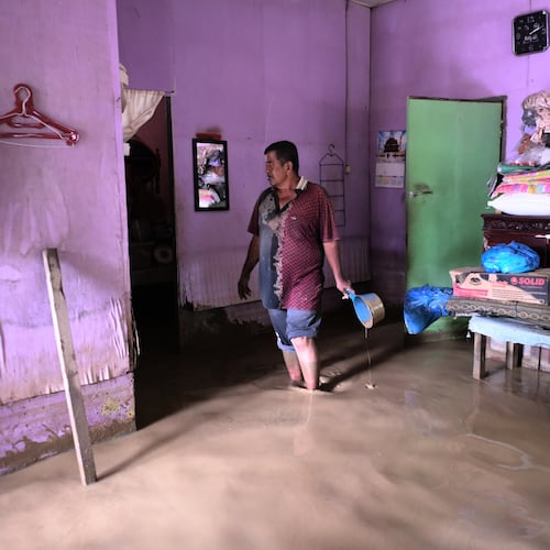 A man stands inside his flooded home in Pidie Jaya, Aceh province, Indonesia, Wednesday, Dec. 3, 2025. (AP Photo/Reza Saifullah)
