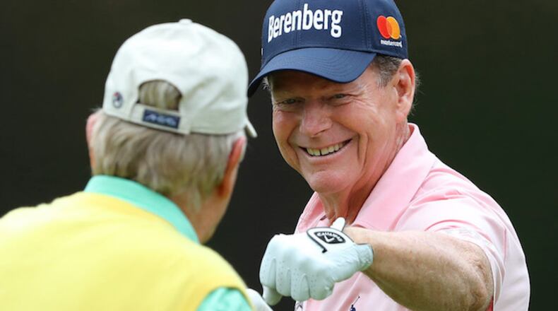Two-time Masters champion Tom Watson gets a fist bump from six-time Masters champion Jack Nicklaus after sinking a birdie putt on the fourth hole during the Par 3 Contest at Augusta National Golf Club on Wednesday, April 4, 2018, in Augusta, Ga. (Curtis Compton/Atlanta Journal-Constitution/TNS)