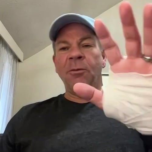 In this image taken from video, Michael Black, a Rhode Island man who helped stop a shooter at a high school hockey game on Monday, holds up his injured hand during an interview with The Associated Press, Thursday, Feb. 19, 2026 in Spartanburg, S.C. (AP Photo)