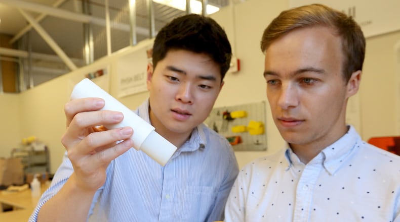 University of Washington engineering students Ha Seung Chung, left, and Shawn Swanson demonstrate their inexpensive replacement for the EpiPen. (Greg Gilbert/Seattle Times/TNS)