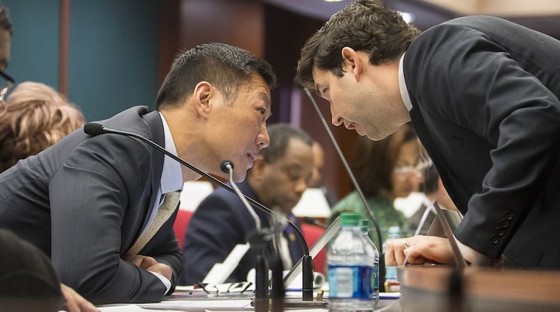 Wenke Lee, left, of the Georgia Technology Institute for Information Security and Privacy speaks Thursday with Ryan Germany of the Georgia Secretary of State’s Office during a Secure, Accessible & Fair Elections (SAFE) Commission public hearing at the Coverdell Legislative Office Building in downtown Atlanta. The SAFE Commission held a public hearing Thursday to discuss and vote on recommendations for Georgia’s next voting system. (ALYSSA POINTER/ALYSSA.POINTER@AJC.COM)