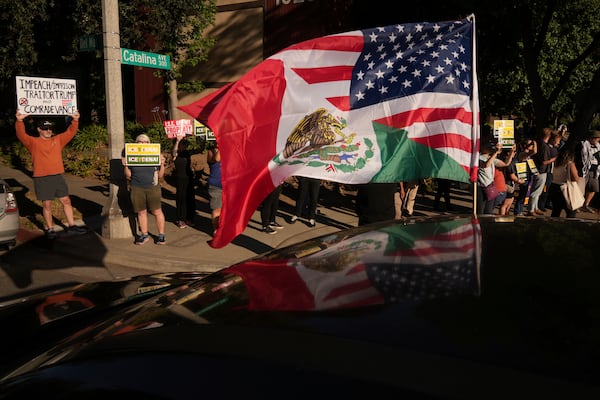 Residents gather during a community vigil on Monday, June 30, 2025, to stand in solidarity with an immigrant family after ICE agents detained Rosalina Luna Vargas on Saturday, June 28, in front of her children, in Pasadena, Calif. (AP Photo/Damian Dovarganes)
