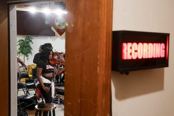 Violinist Solange Maughn, rehearses with the Renaissance Orchestra at 800 East Studio. (Arvin Temkar/AJC)