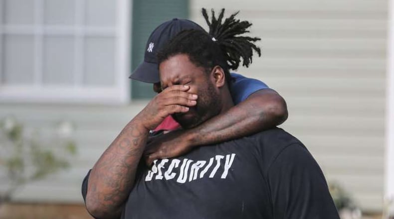 Anthony Lewis grieves at the scene where his brother, Cedric Clark was found dead Wednesday. The body of Cedric Clark, 17, was found by a homeowner in the 5800 block of Eagles Feather Lane, about a mile from his Riverdale home, Clayton County police said. JOHN SPINK /JSPINK@AJC.COM